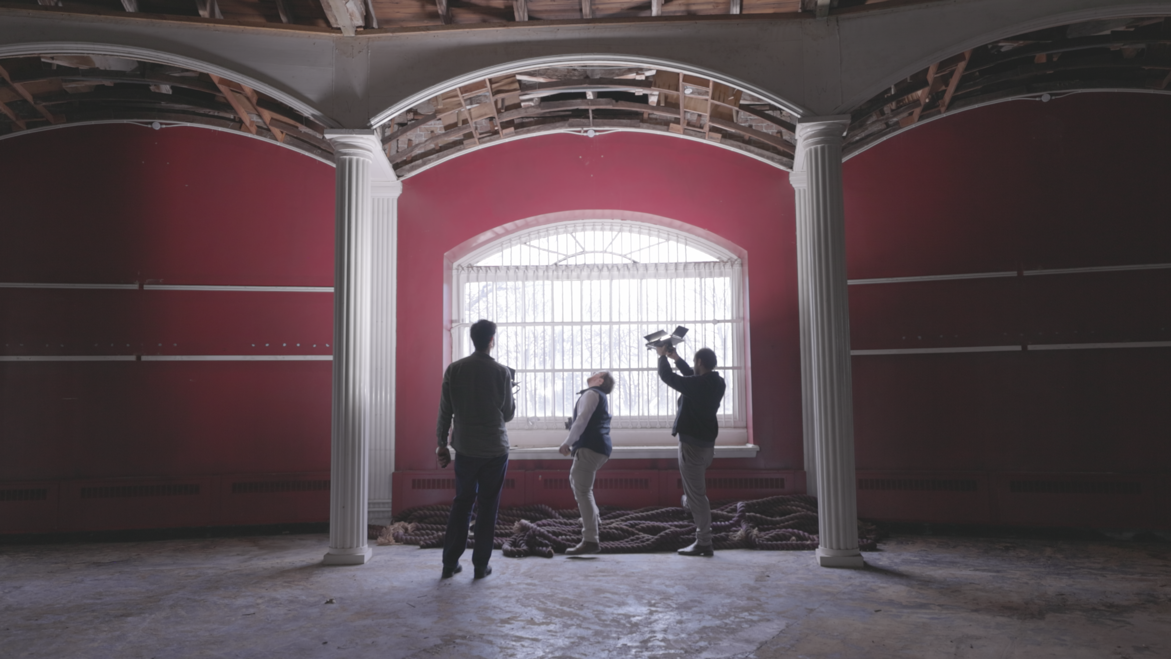 The colonnade interior with cast iron columns and arched windows.